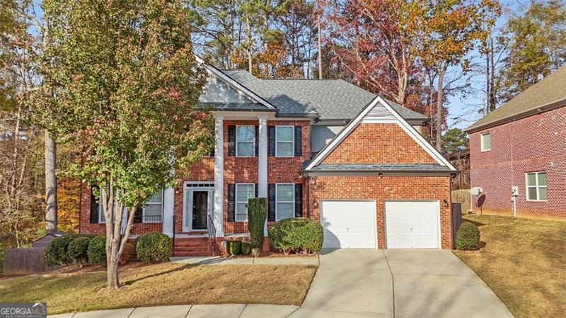 view of front of home with a front yard and a garage