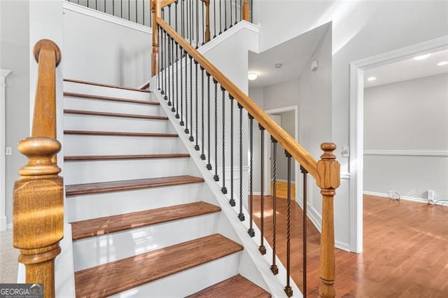 staircase with wood-type flooring