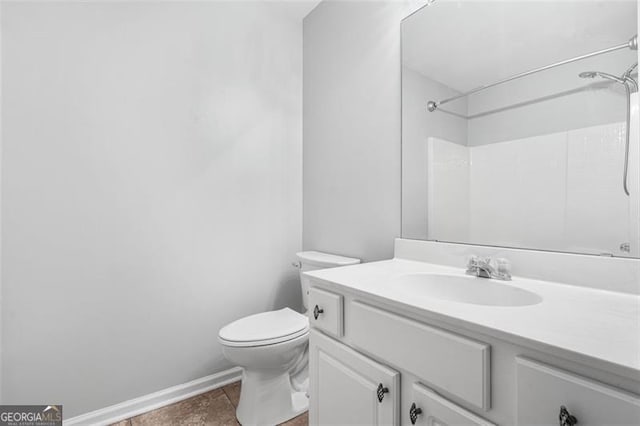 bathroom with tile patterned floors, vanity, toilet, and walk in shower