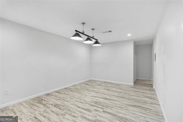 unfurnished room featuring light hardwood / wood-style floors