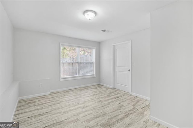 empty room with light hardwood / wood-style floors