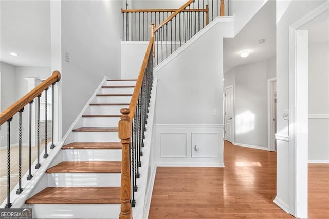 stairs featuring wood-type flooring