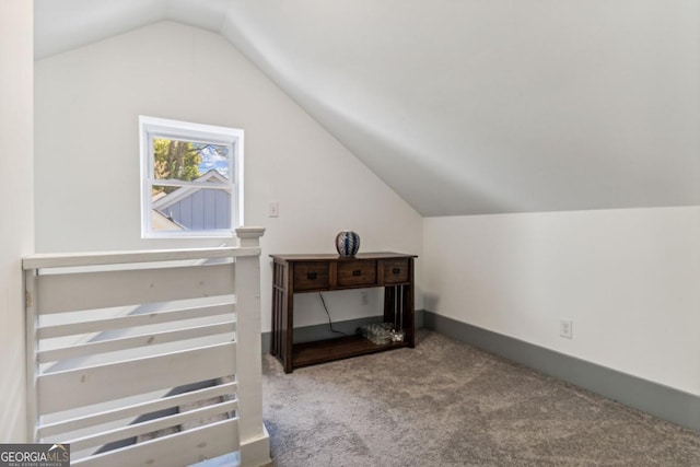 additional living space featuring light colored carpet and vaulted ceiling