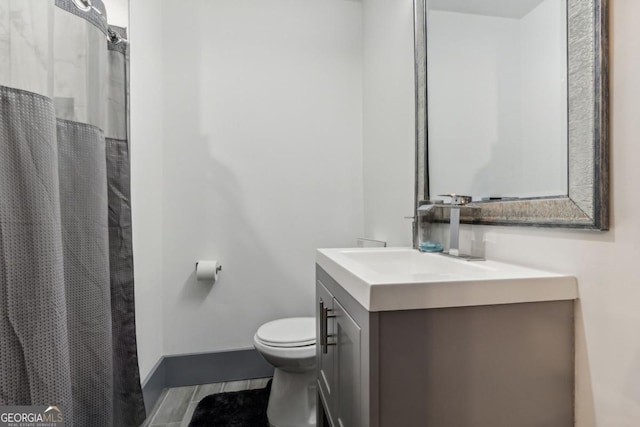 bathroom with tile patterned flooring, vanity, and toilet