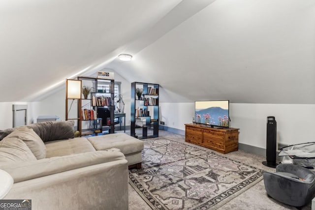 living room featuring carpet and vaulted ceiling