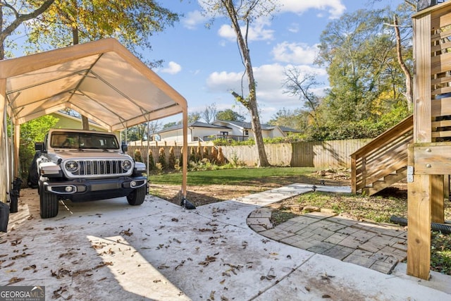 view of parking with a carport and a yard