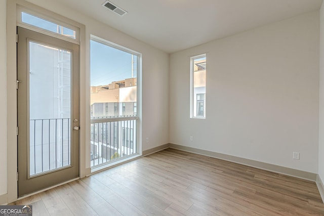 spare room featuring light hardwood / wood-style floors