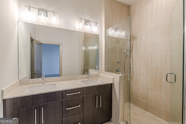 bathroom with vanity and a shower with shower door