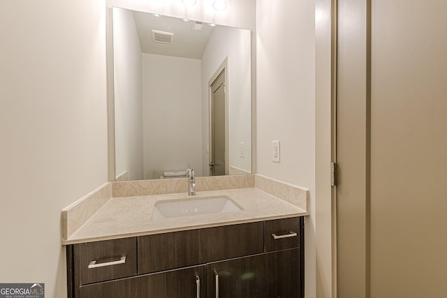 bathroom featuring vanity and toilet