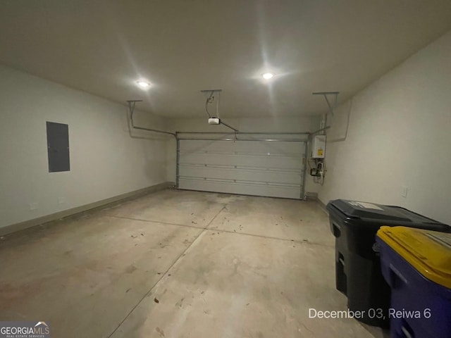 garage featuring electric panel and water heater