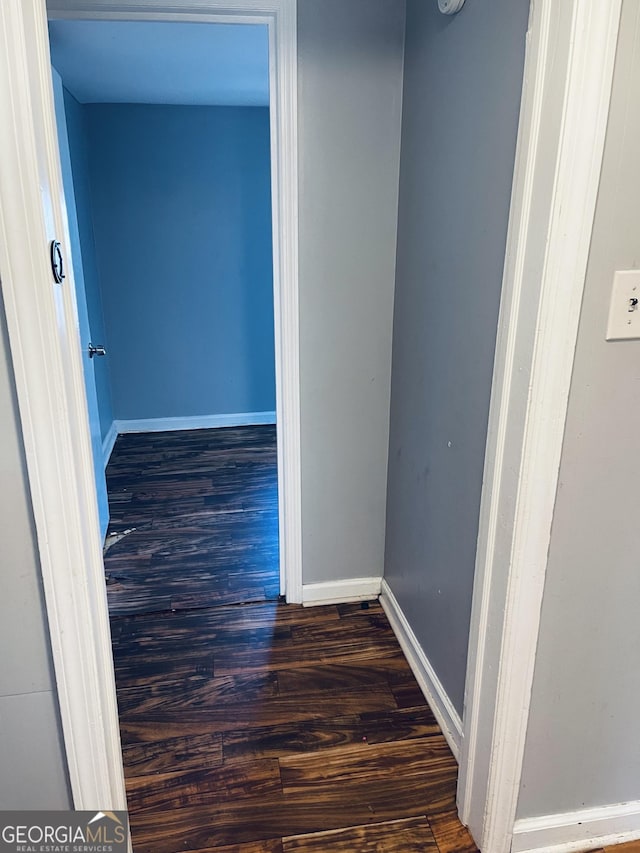 corridor with dark hardwood / wood-style floors