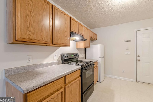 kitchen featuring a textured ceiling, white fridge, and black electric range oven