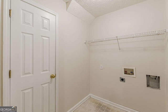 clothes washing area with electric dryer hookup, a textured ceiling, and hookup for a washing machine