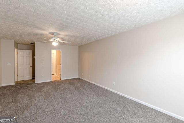 carpeted spare room with ceiling fan and a textured ceiling