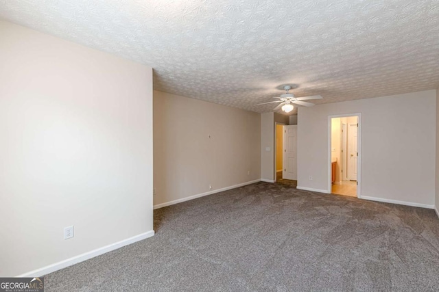 carpeted spare room with ceiling fan and a textured ceiling