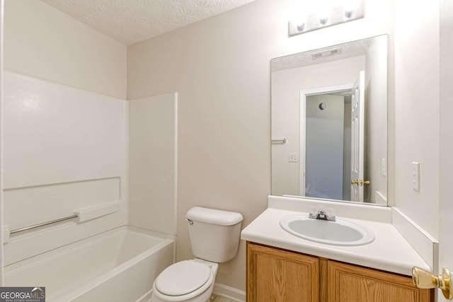 full bathroom with vanity, a textured ceiling, shower / bath combination, and toilet