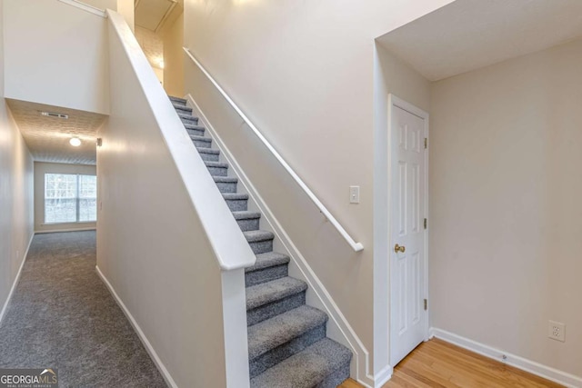 staircase featuring hardwood / wood-style floors