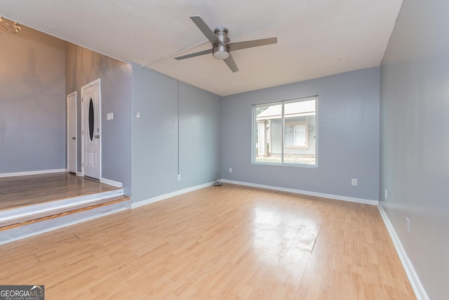 spare room featuring ceiling fan, a textured ceiling, and light wood-type flooring