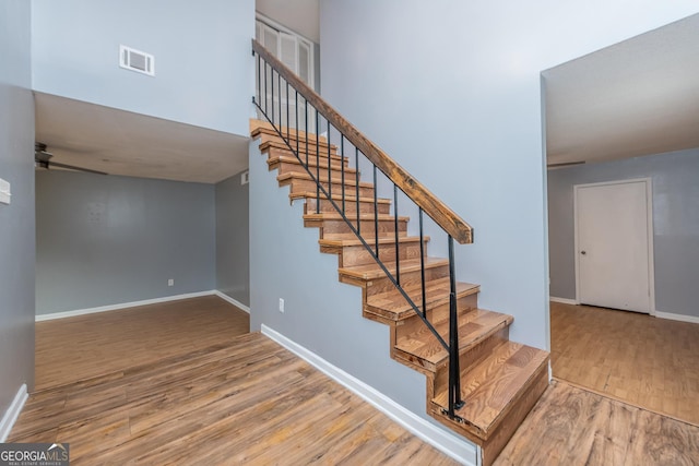 stairs with hardwood / wood-style flooring