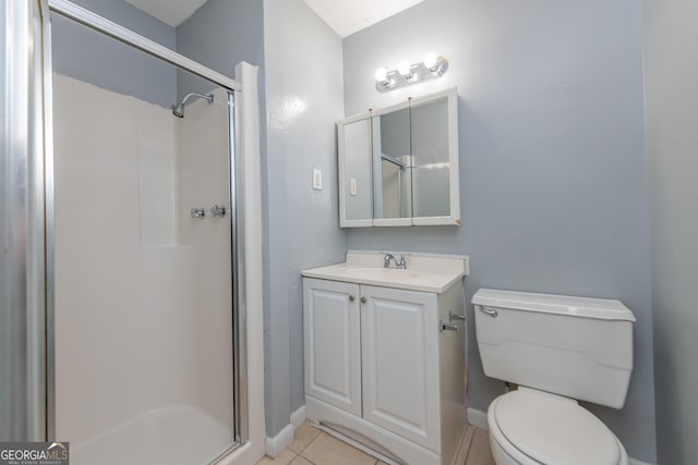 bathroom with tile patterned flooring, vanity, toilet, and walk in shower