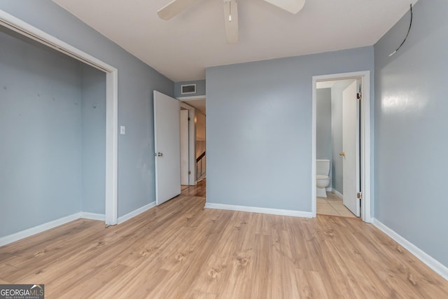 unfurnished bedroom featuring ceiling fan, light wood-type flooring, and connected bathroom