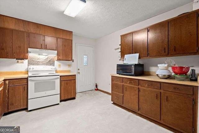 kitchen featuring a textured ceiling and electric range