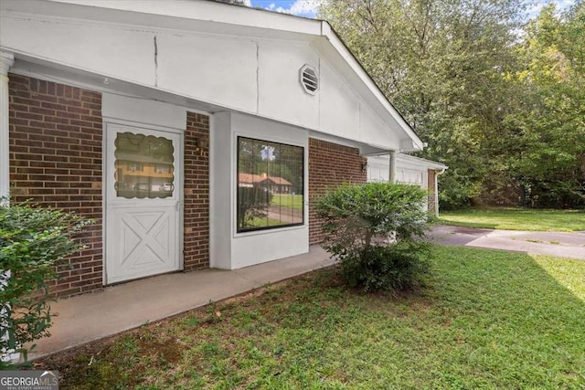 doorway to property featuring a yard