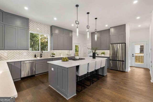 kitchen with a center island, stainless steel appliances, and dark wood-type flooring