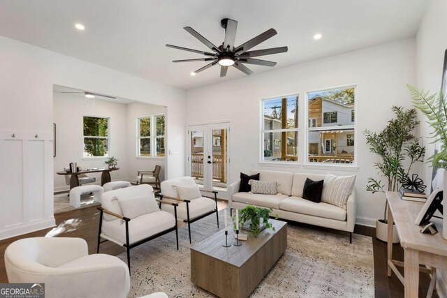 living room featuring ceiling fan and french doors