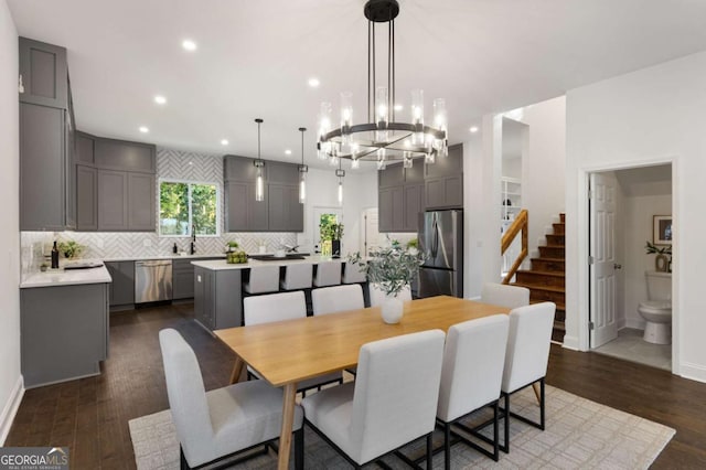 dining room featuring a chandelier, dark hardwood / wood-style flooring, and sink