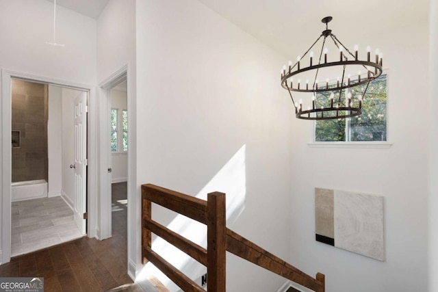 interior space with hardwood / wood-style floors, lofted ceiling, and a chandelier