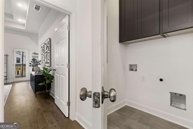 clothes washing area with cabinets, french doors, hookup for a washing machine, hookup for an electric dryer, and dark hardwood / wood-style flooring