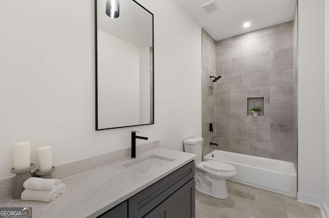 full bathroom with tiled shower / bath combo, toilet, and vanity