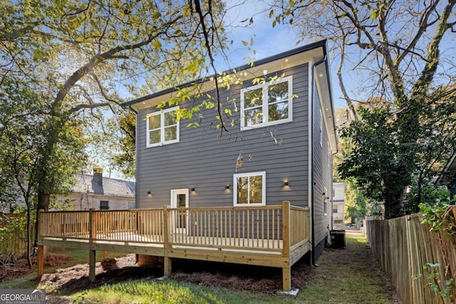 rear view of property with central AC unit and a deck