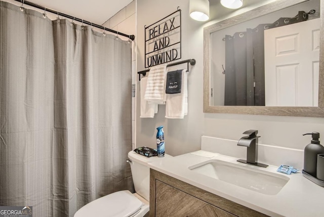 bathroom featuring vanity and toilet