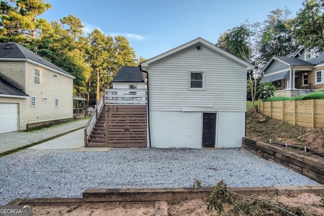 back of house featuring a wooden deck