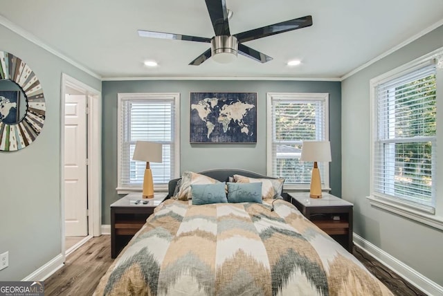 bedroom featuring ceiling fan, crown molding, and wood-type flooring