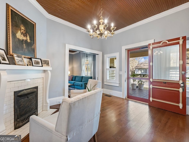 living room with ornamental molding, a fireplace, wooden ceiling, and hardwood / wood-style flooring