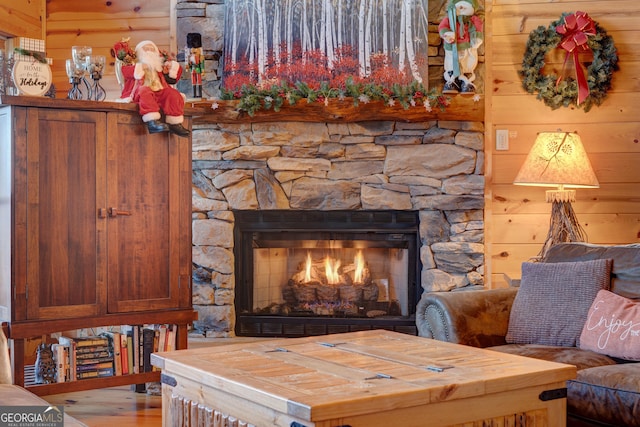 details featuring a stone fireplace and wood walls