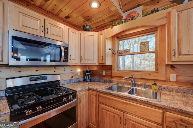 kitchen with appliances with stainless steel finishes, wood ceiling, light brown cabinetry, and sink