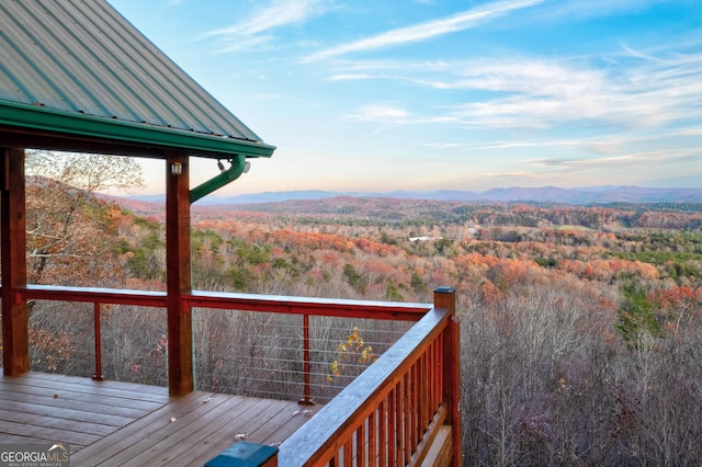 deck at dusk featuring a mountain view