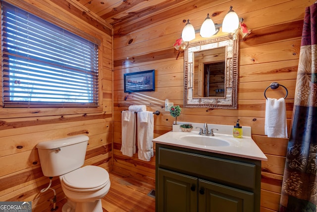 bathroom featuring wood walls, vanity, and hardwood / wood-style flooring