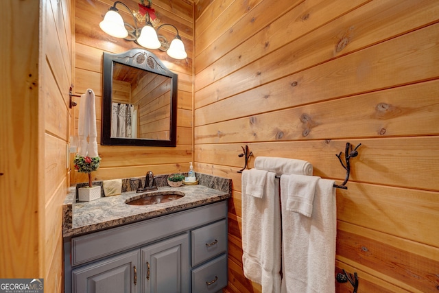 bathroom with wooden walls and vanity