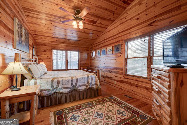 bedroom with hardwood / wood-style floors, lofted ceiling, wood ceiling, and wooden walls