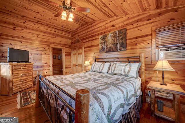 bedroom featuring lofted ceiling, dark wood-type flooring, wooden ceiling, wooden walls, and ceiling fan