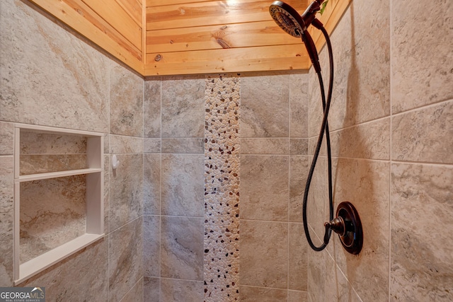 interior details with a tile shower