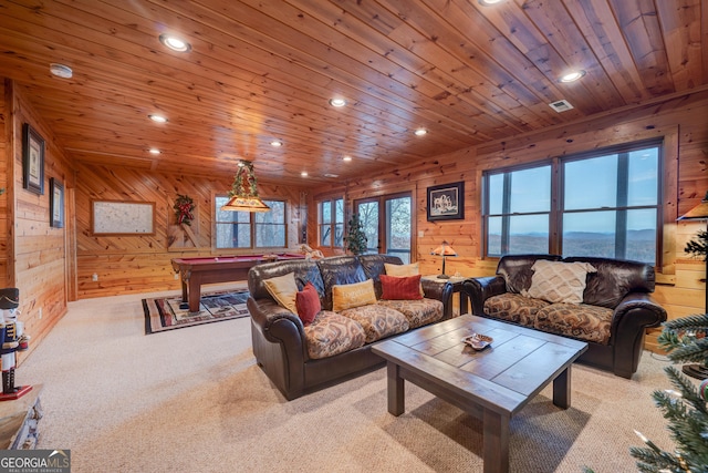 carpeted living room with wooden ceiling, wooden walls, and billiards