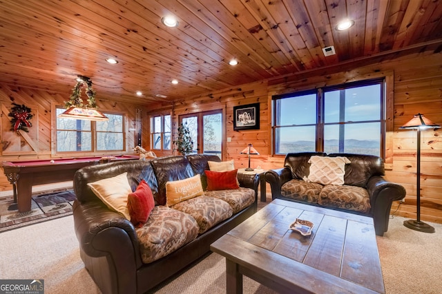 carpeted living room featuring billiards, wood ceiling, and wooden walls