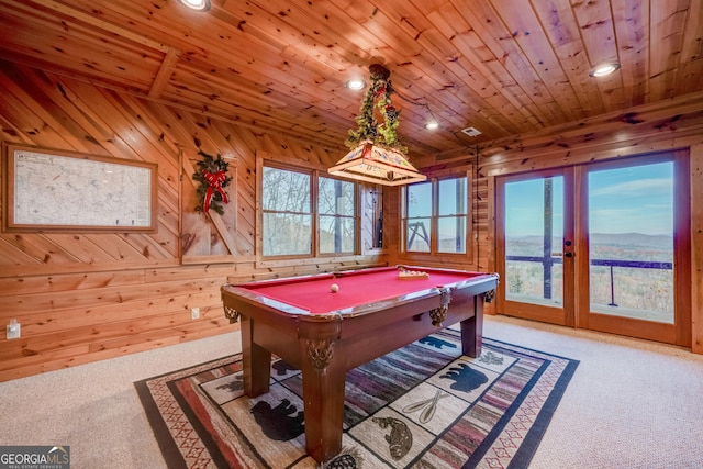 rec room with wood walls and wooden ceiling