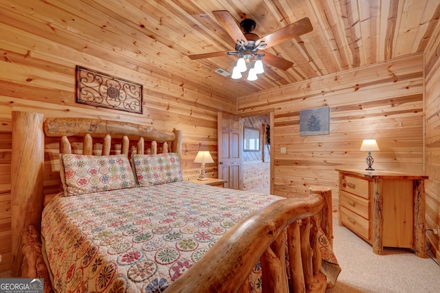 bedroom featuring ceiling fan, wood walls, light colored carpet, and wooden ceiling